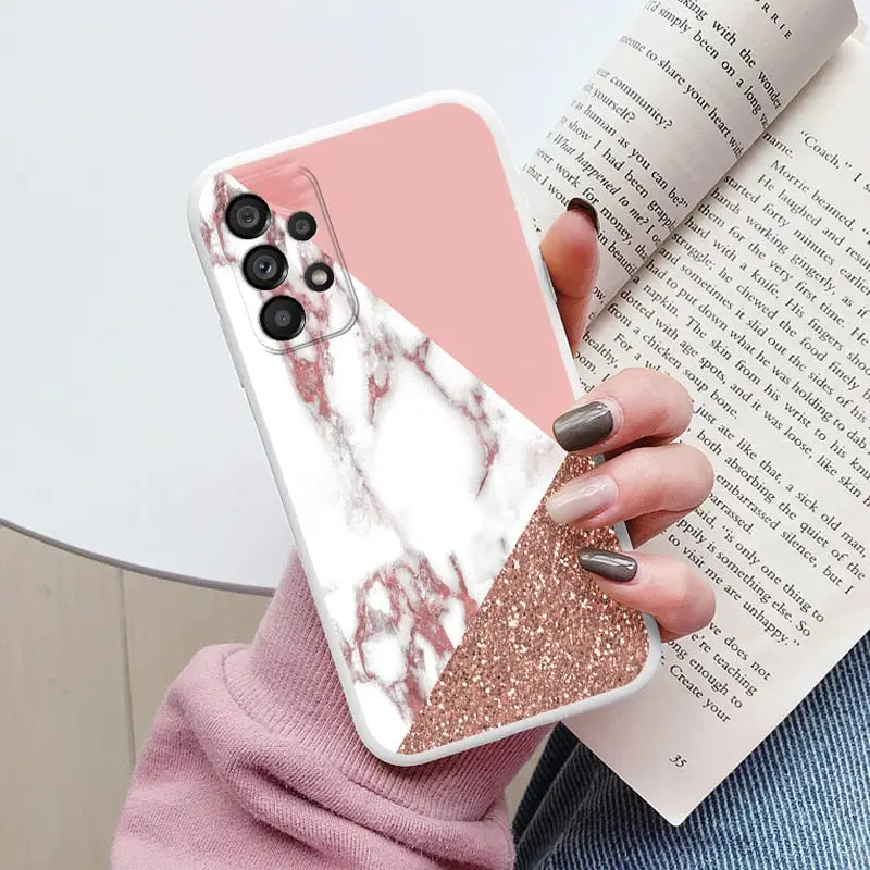 a woman holding a pink and white marble phone case