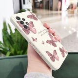 a woman holding a phone case with butterflies on it