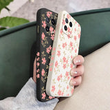 a woman holding a phone case with pink flowers on it