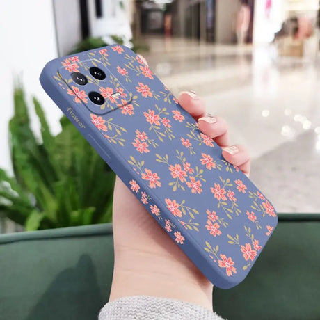 a woman holding a phone case with flowers on it