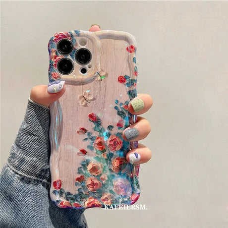 a woman holding a phone case with flowers on it