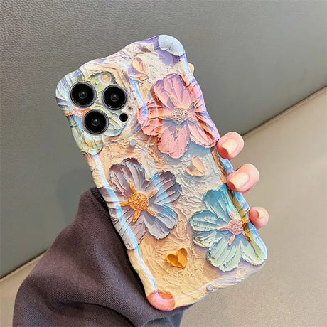 a woman holding a phone case with flowers on it