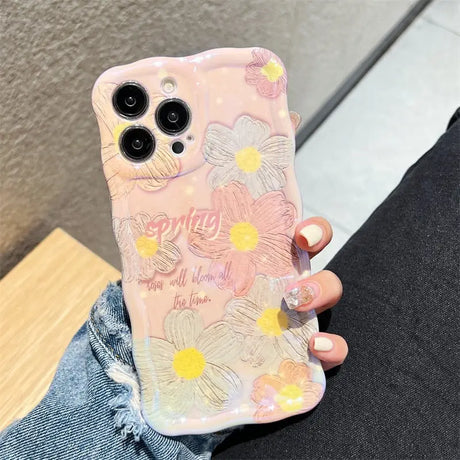 a woman holding a phone case with flowers on it