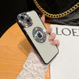 a woman holding a phone case with a ring on it