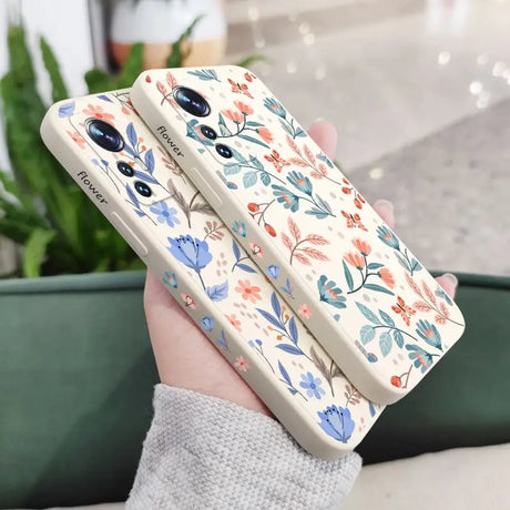 a woman holding a phone case with a floral pattern