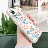 a woman holding a phone case with a floral pattern