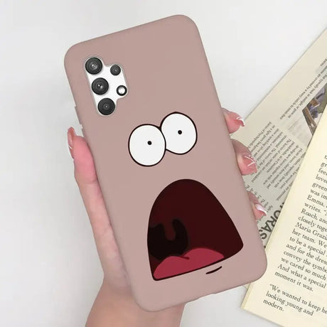 a person holding a phone case with a cartoon face