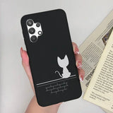 a woman holding a phone case with a cat on it