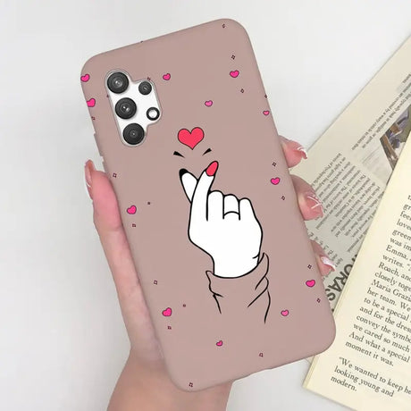 a woman holding a phone case with a heart on it