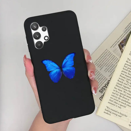 a woman holding a phone case with a blue butterfly on it