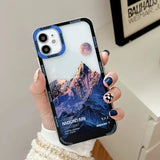 a woman holding a phone case with a mountain scene