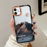 a woman holding a phone case with a mountain photo on it
