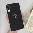 a woman holding a phone case with a heart on it