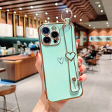 a woman holding up a phone case with a heart on it