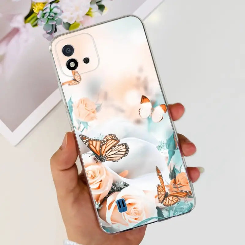 a woman holding a phone case with a butterfly pattern