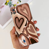 a woman holding a phone case with a heart pattern