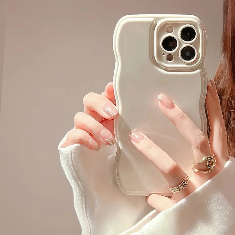 a woman holding a phone case in her hand