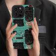 a woman holding a phone case with a pattern on it