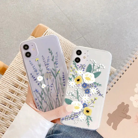 a woman holding a phone case with flowers on it