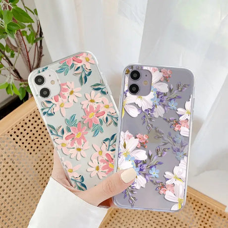 a woman holding a phone case with flowers on it