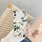 a woman holding a phone case with a white flower pattern