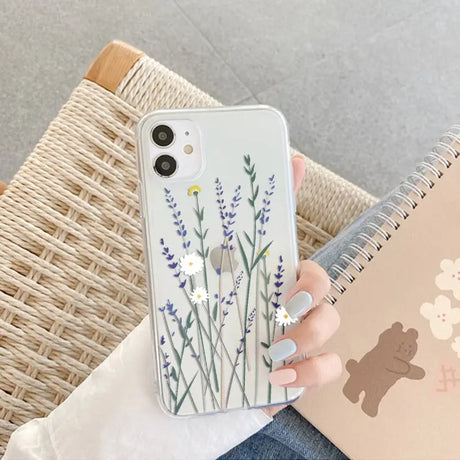 a woman holding a phone case with a flower design