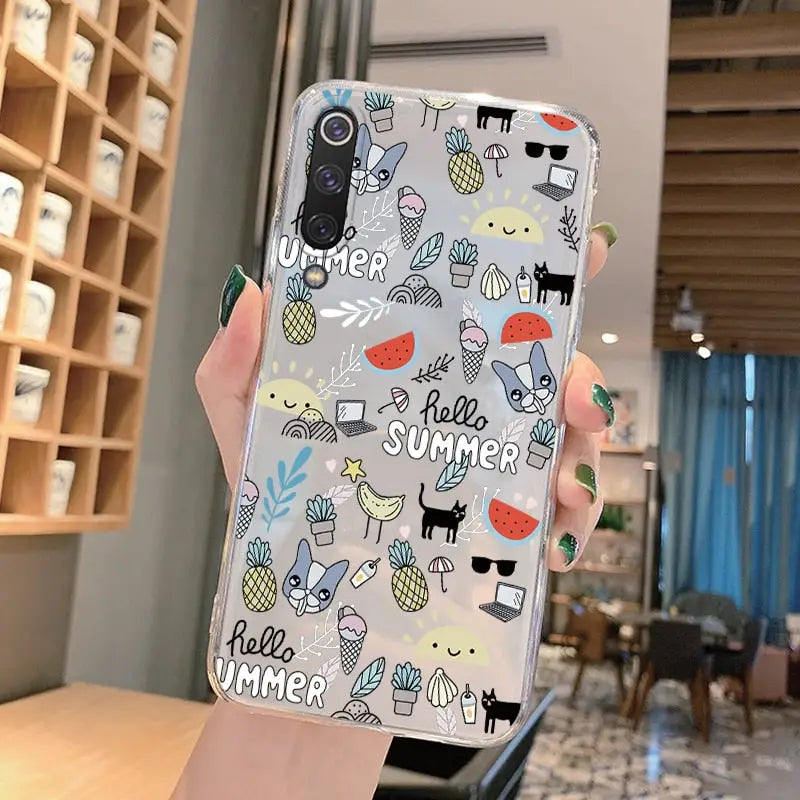 a woman holding up a phone case with a pattern of cats and dogs