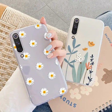 a woman holding a phone case with flowers on it