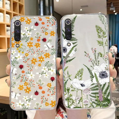 a woman holding up a phone case with flowers on it