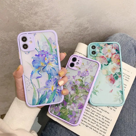 a woman holding a phone case with flowers on it