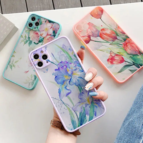 a woman holding a phone case with flowers on it