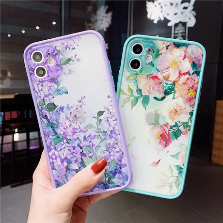 a woman holding a phone case with flowers on it