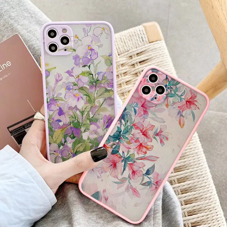 a woman holding a phone case with flowers on it