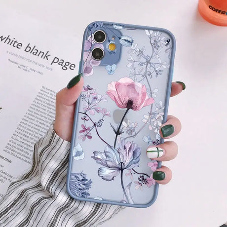 a woman holding a phone case with flowers on it