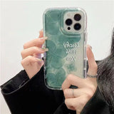 a woman holding a phone case with a green marble pattern