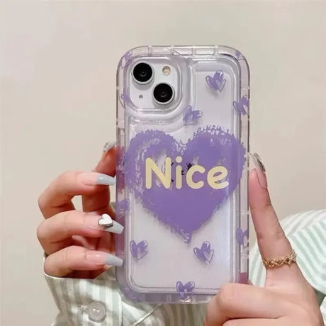 a woman holding a phone case with a heart on it