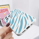 a person holding a phone case with zebra print