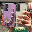 a woman holding two iphone cases with glitter and heart charms