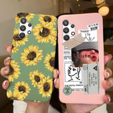 a woman holding up two phone cases with sunflowers on them