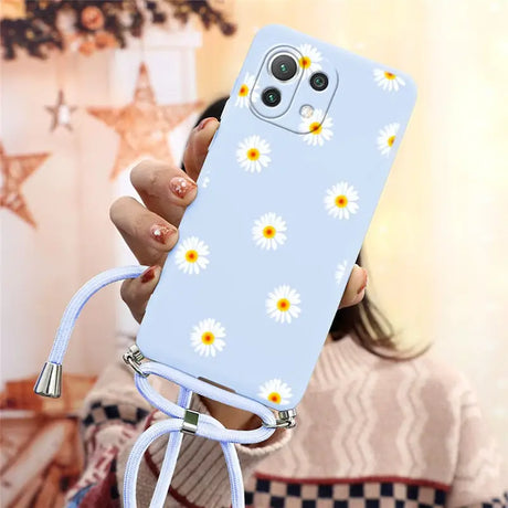 there is a woman holding a phone with a daisy pattern on it