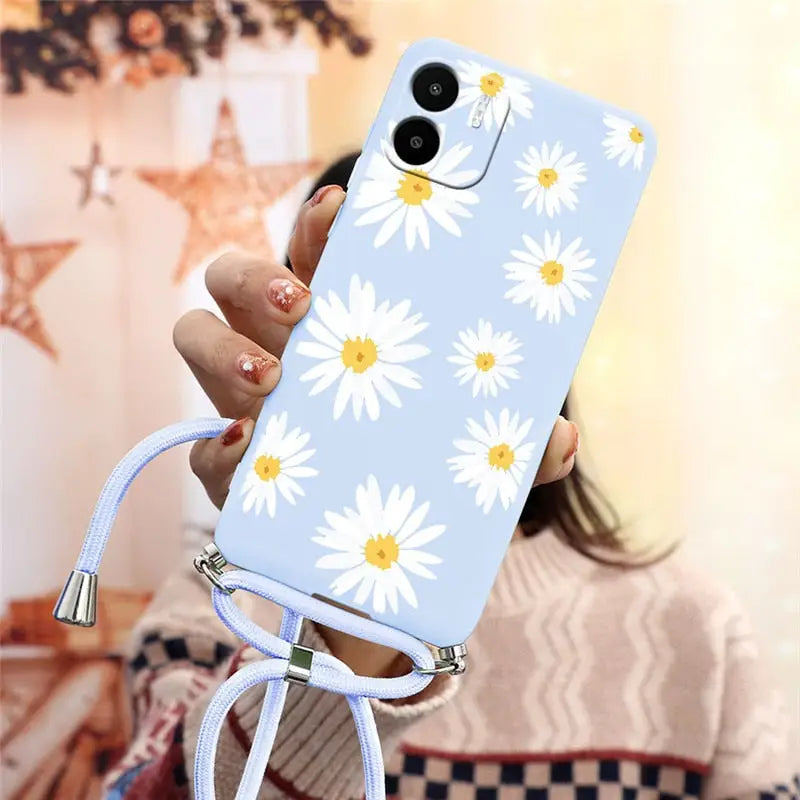 there is a woman holding a phone with a flower design on it