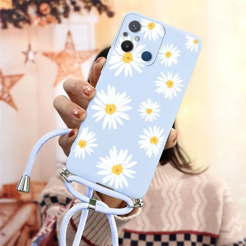 a woman holding a phone with a flower design on it