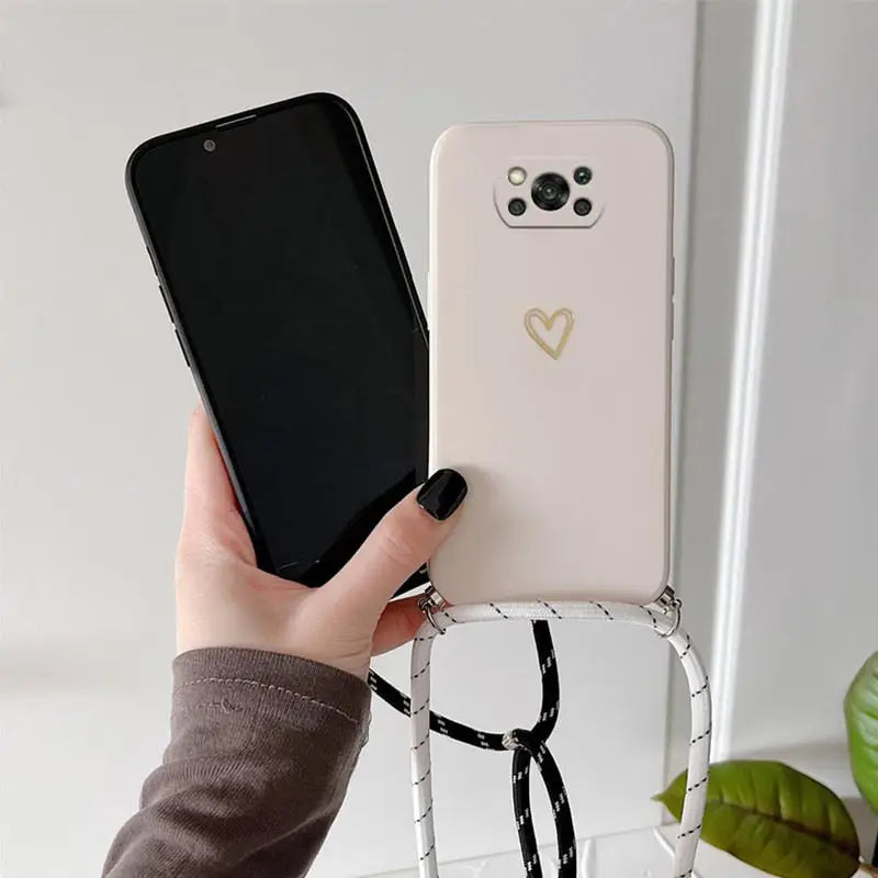 a woman holding a phone with a heart on it