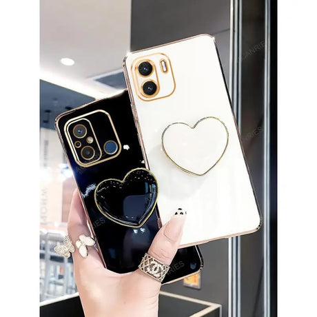 a woman holding a phone case with a heart on it