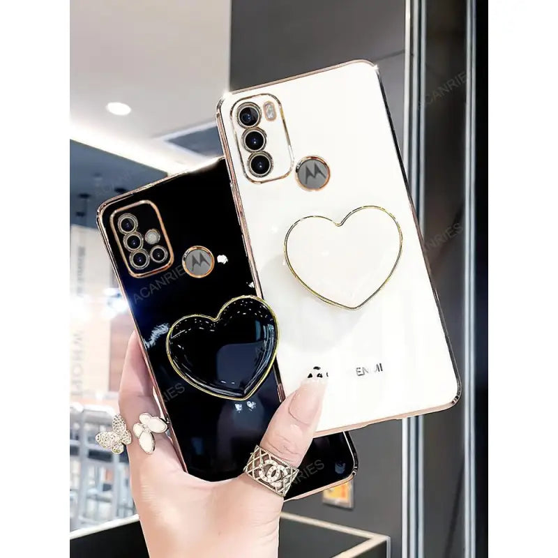 a woman holding a phone case with a heart