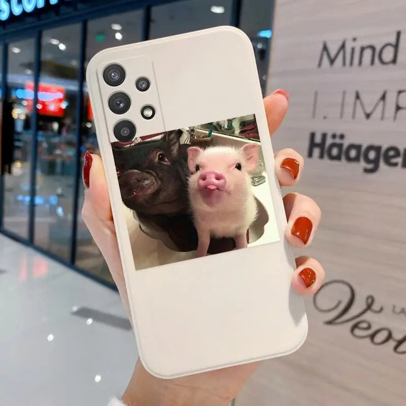 a woman holding a phone with a photo of a ferret