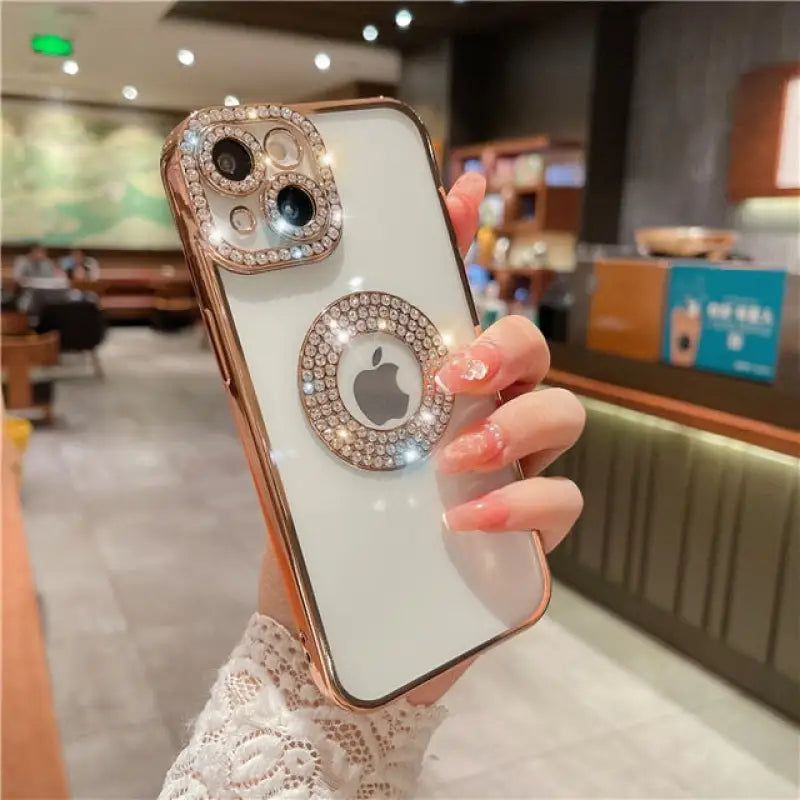 a woman holding a phone with a diamond ring on it
