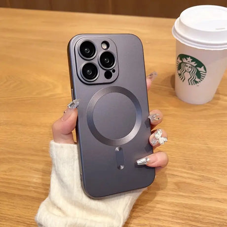 a woman holding a phone with a starbucks cup in the background