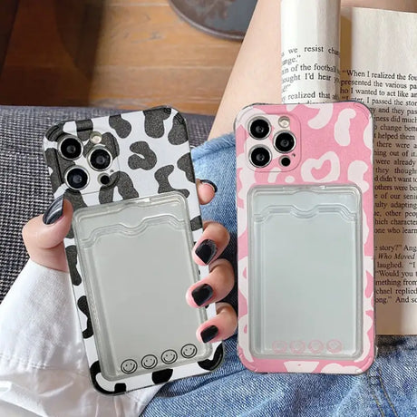 a woman holding a pink and black phone case