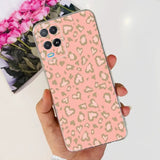 a woman holding a pink and gold leopard print iphone case